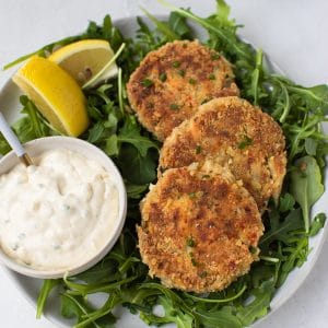 crab cakes on a bed of arugula