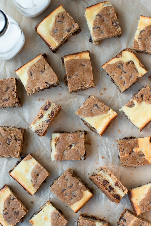 Chocolate Chip Cookie Cheesecake Bars on parchment paper cut into small squares