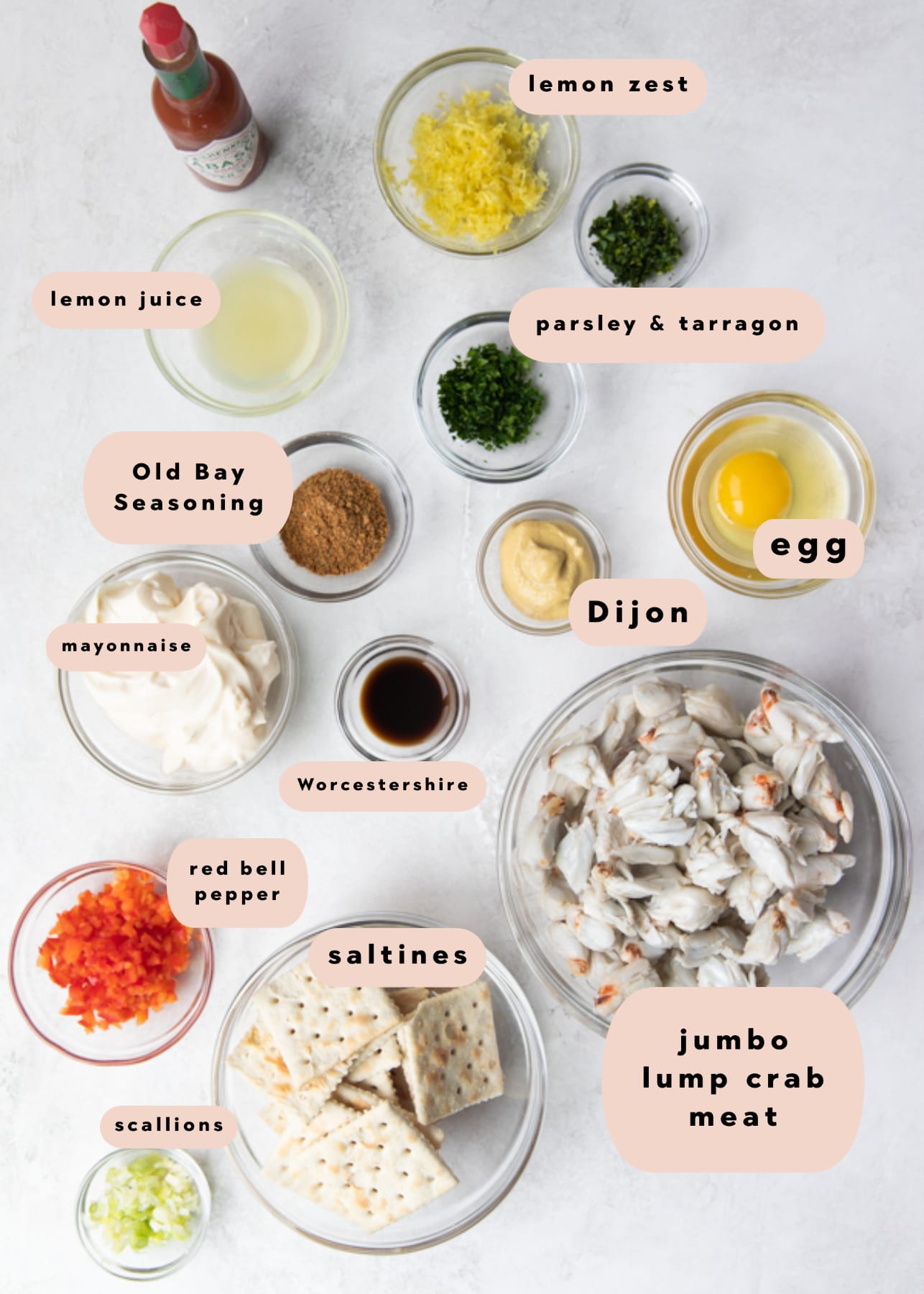 ingredients needed to make crab cakes divided into small bowls 
