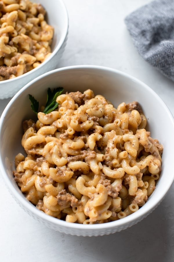macaroni in a white bowl with ground beef and cheese