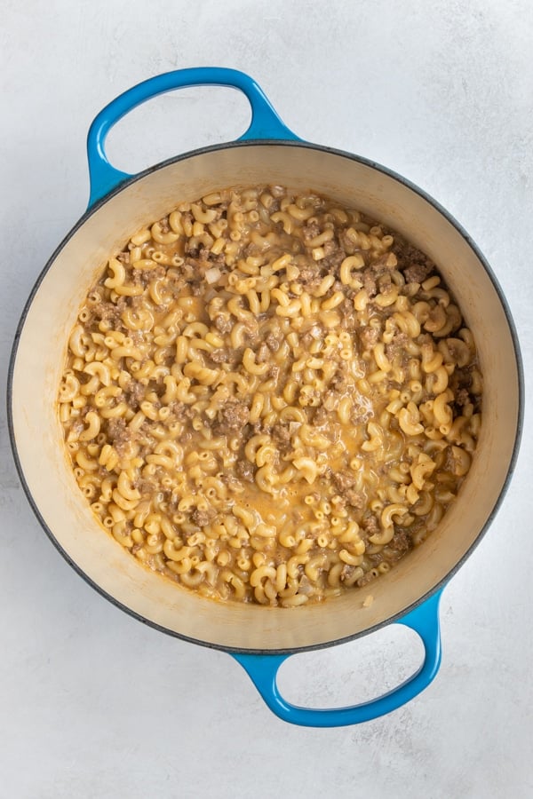 macaroni in a large blue pot with ground beef and cheese