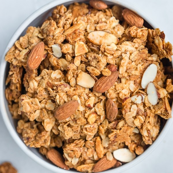 granola in a white bowl with almonds