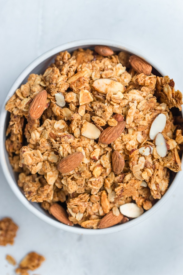 granola in a white bowl with almonds