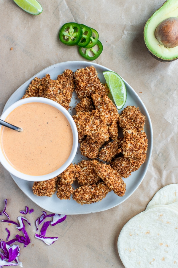 mahi mahi fish pieces coated in toasted panko breadcrumbs on a white plate