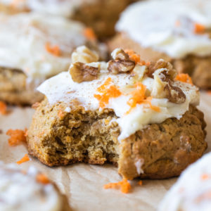 a bite taken out of a cookie with cream cheese frosting on top