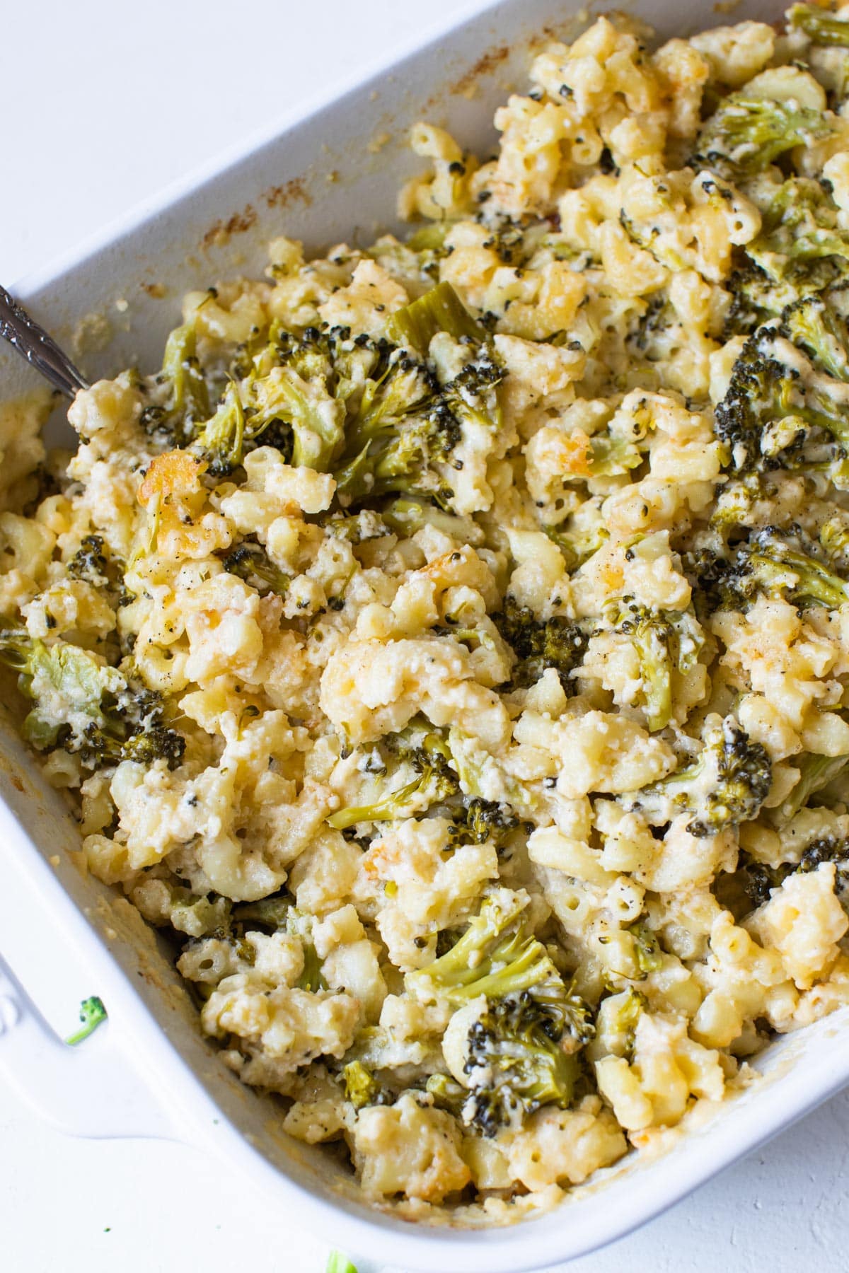 macaroni and cheese with broccoli in a white casserole dish