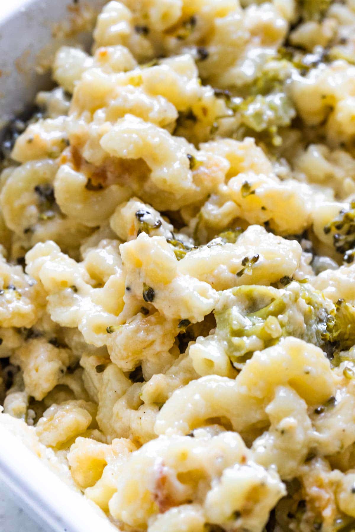a close up image of macaroni and cheese with broccoli 