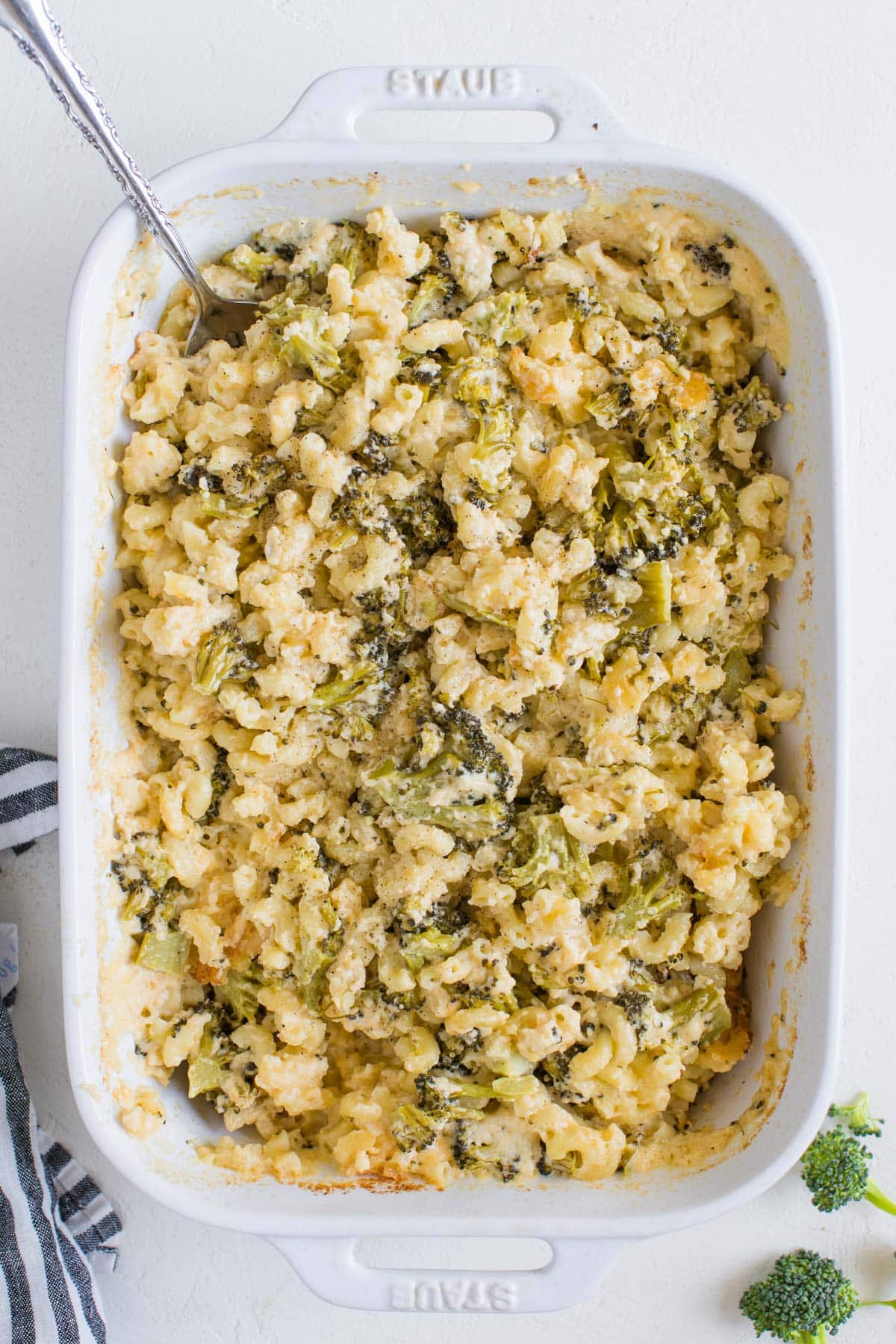 macaroni and cheese with broccoli in a white casserole dish