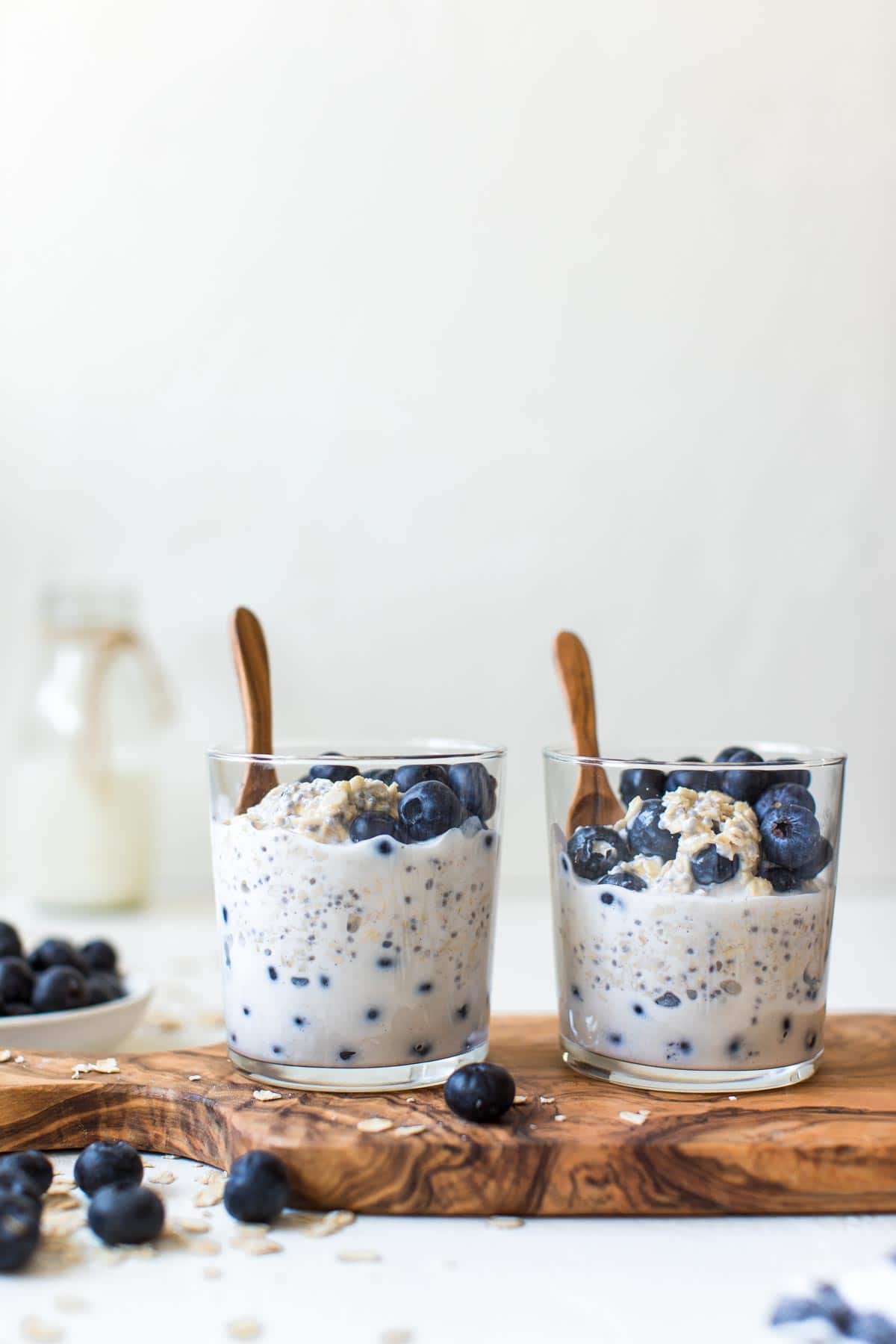 overnight oatmeal in glasses with small wooden spoons