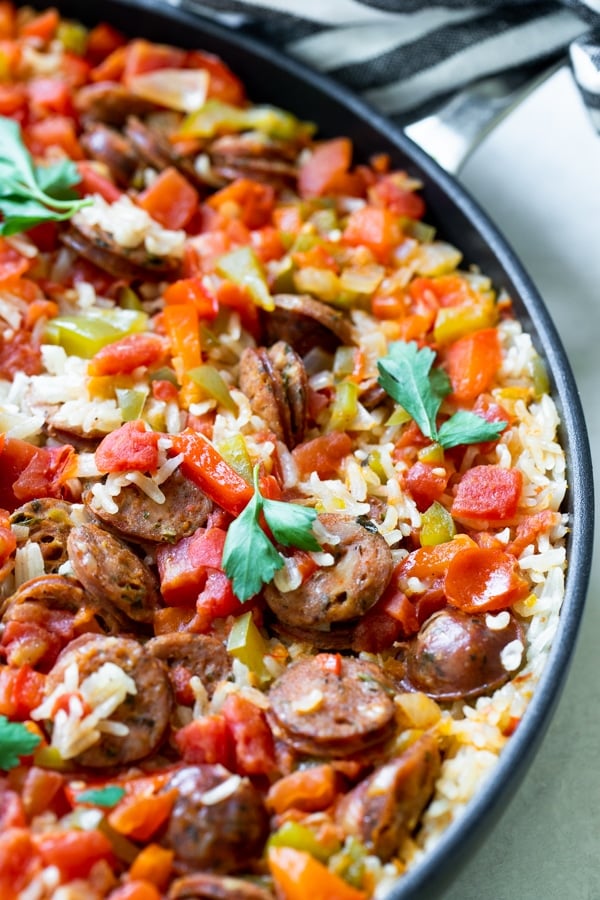 Sausage, Peppers and Rice in a large nonstick skillet topped with parsley 