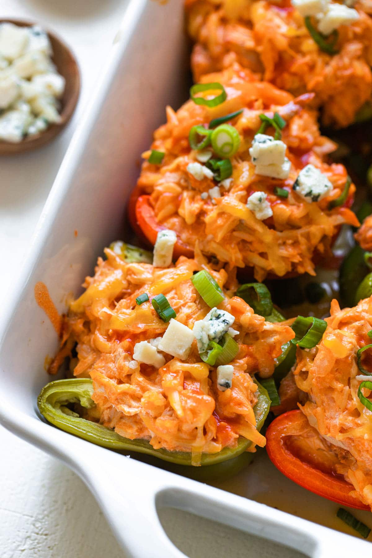 stuffed peppers in a white casserole dish