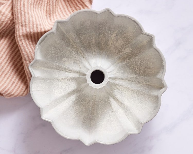 Bundt pan coated with shortening and flour, creating a nonstick layer to help the cake release cleanly after baking.