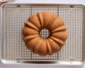 reshly baked chocolate chip Bundt cake cooling upside down on a wire rack set over a baking sheet.