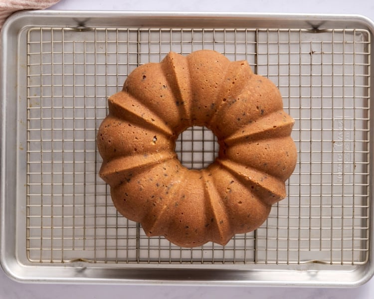 reshly baked chocolate chip Bundt cake cooling upside down on a wire rack set over a baking sheet.