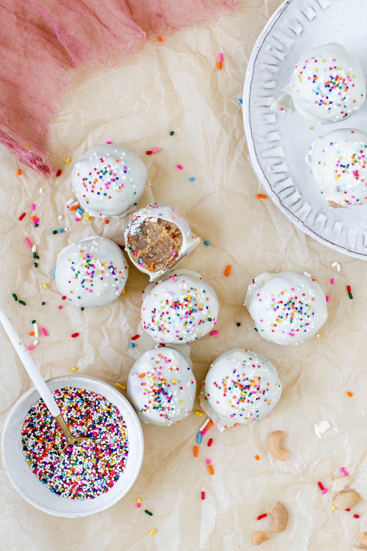 cake bites on parchment paper topped with sprinkles