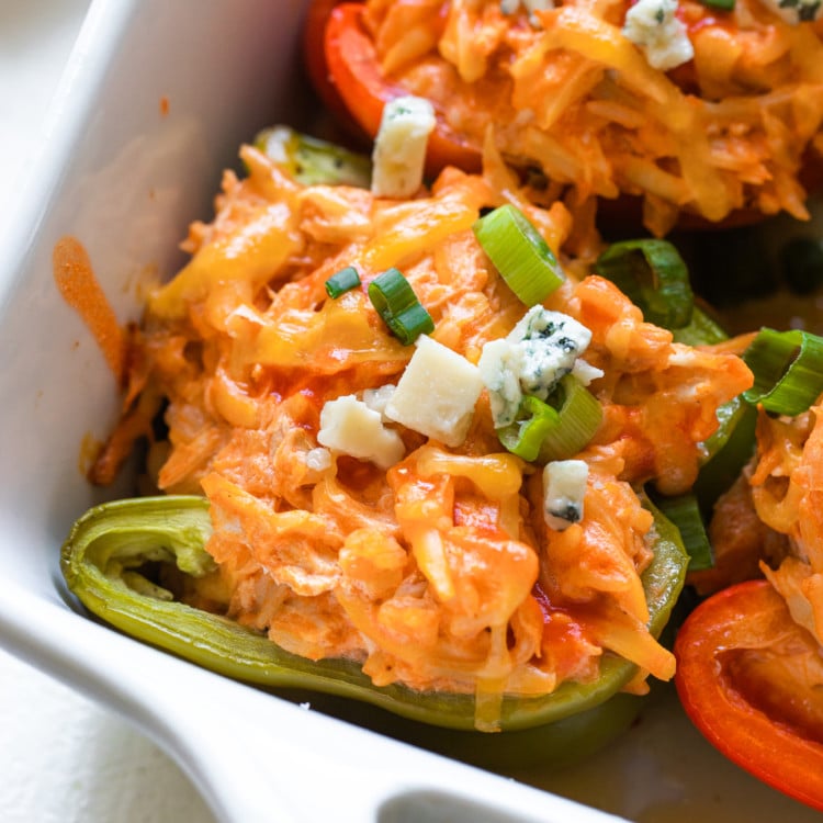 stuffed bell peppers in a white casserole dish