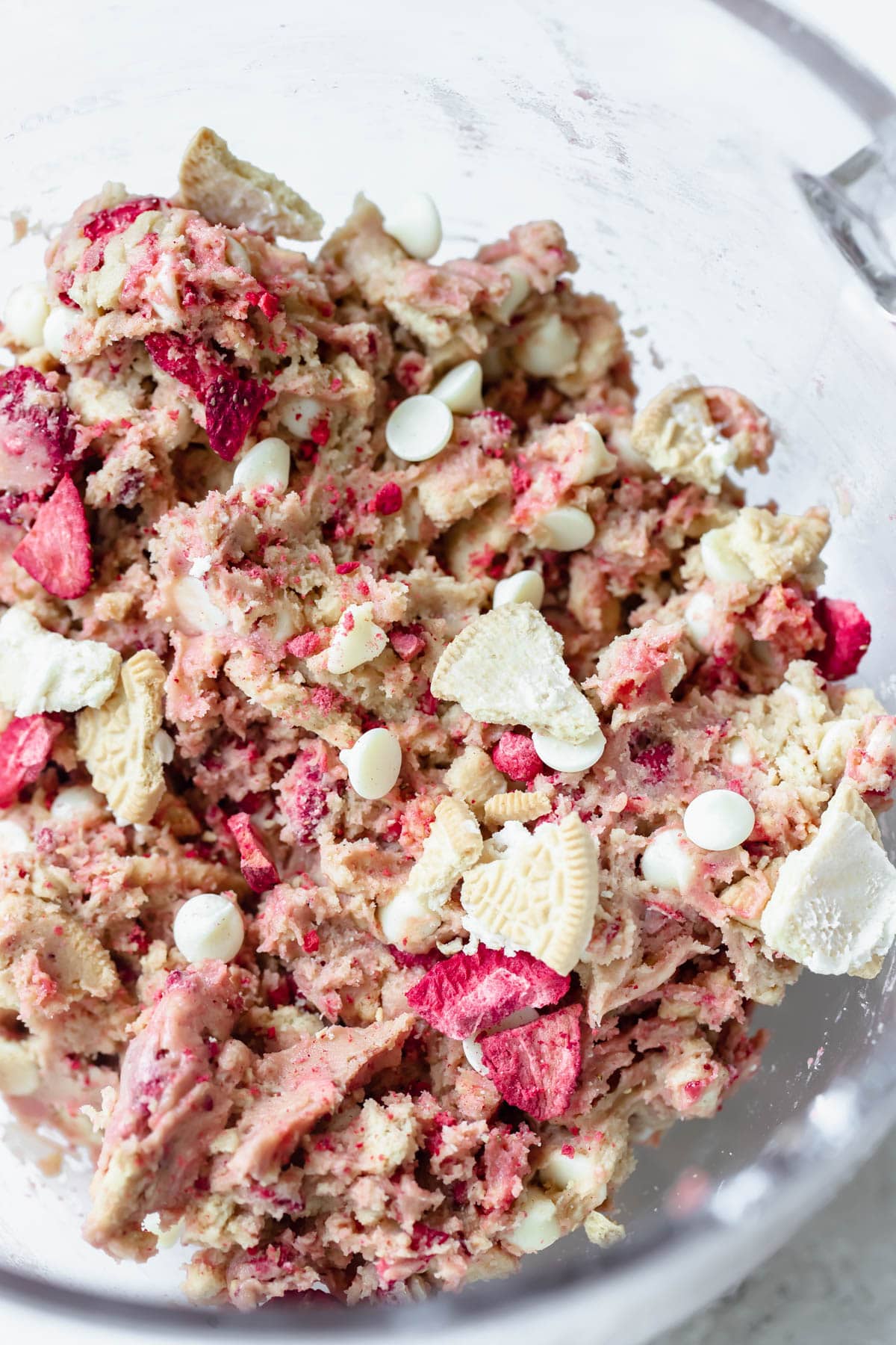 strawberry cookie dough in a glass mixing bowl