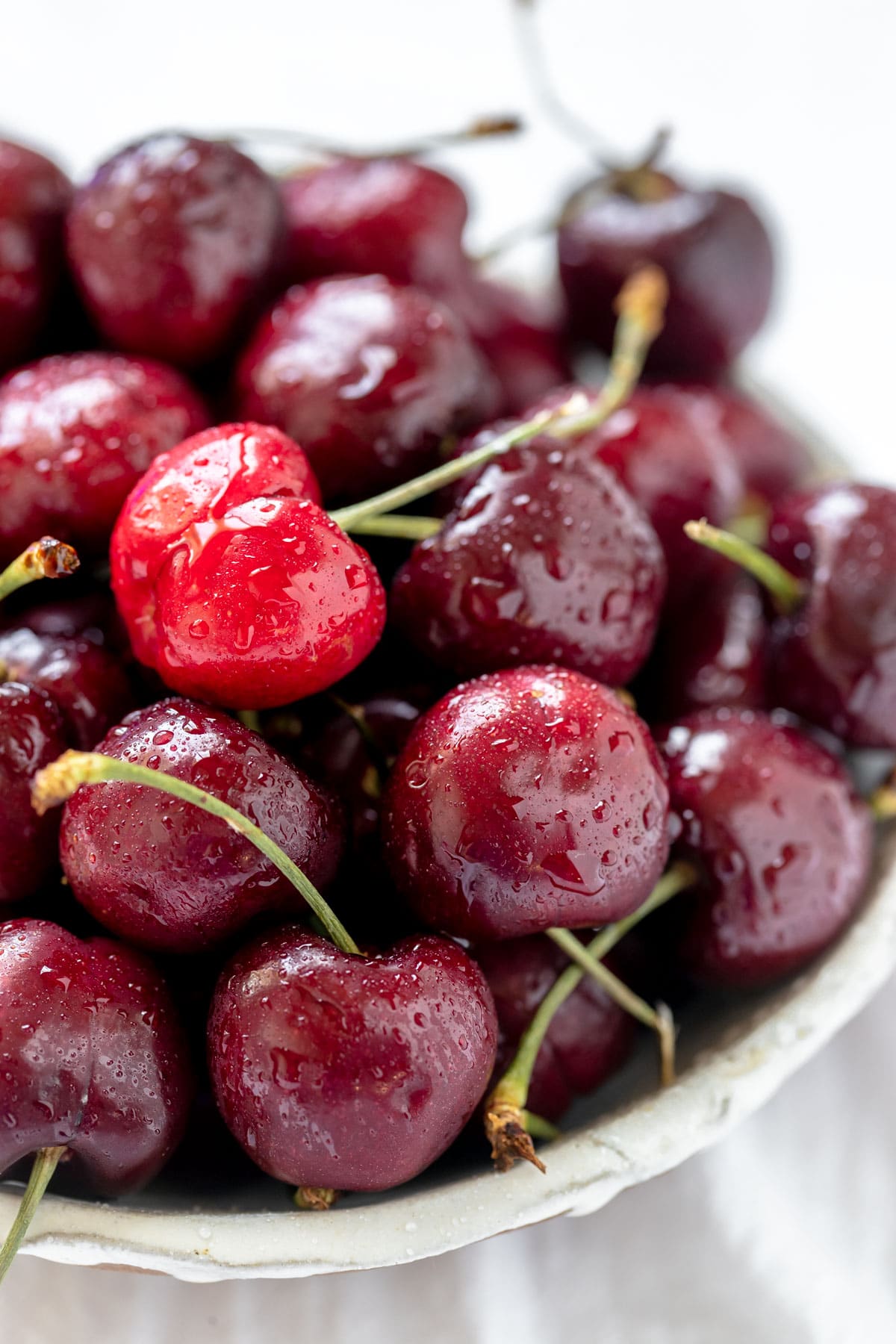 fresh cherries in a white bowl