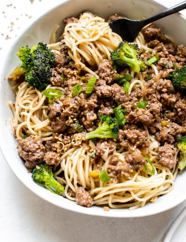 ground beef over noodles in a white bowl