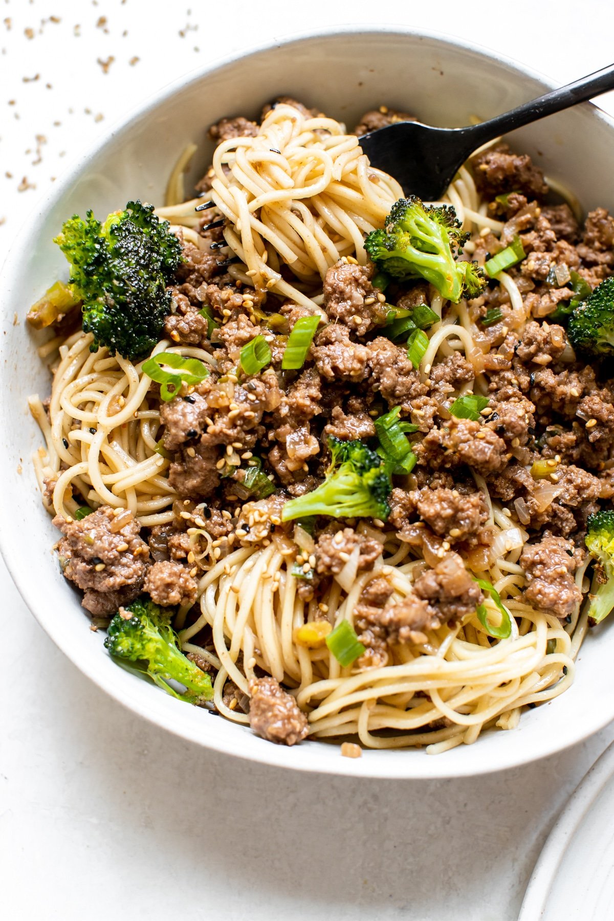 ground beef over noodles in a white bowl