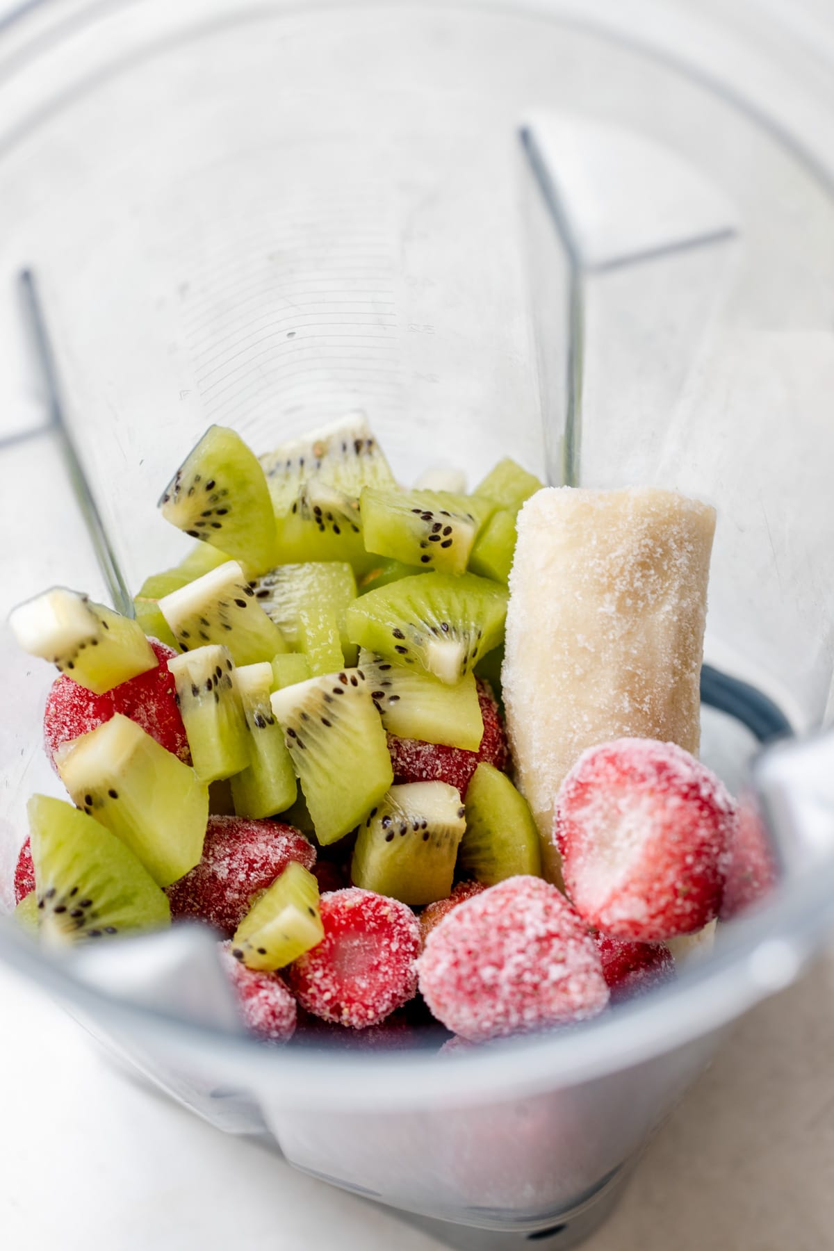 strawberries, banana and kiwi in a blender