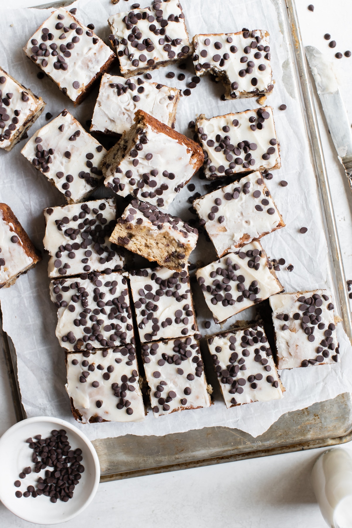 banana bars with mini chocolate chips on a sheet of parchment paper