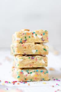 a close up photo of funfetti cookie bars stacked on top of each other