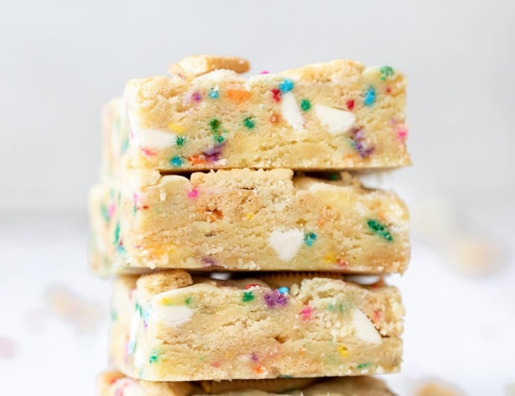 a close up photo of funfetti cookie bars stacked on top of each other