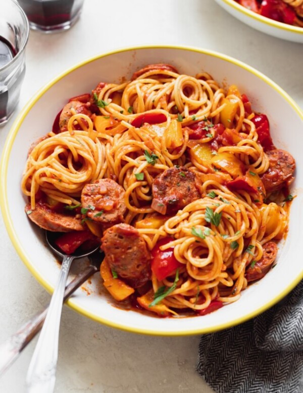 sausage and spaghetti in a white bowl