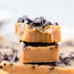 pumpkin fudge bars stacked on top of each other topped with mini chocolate chips