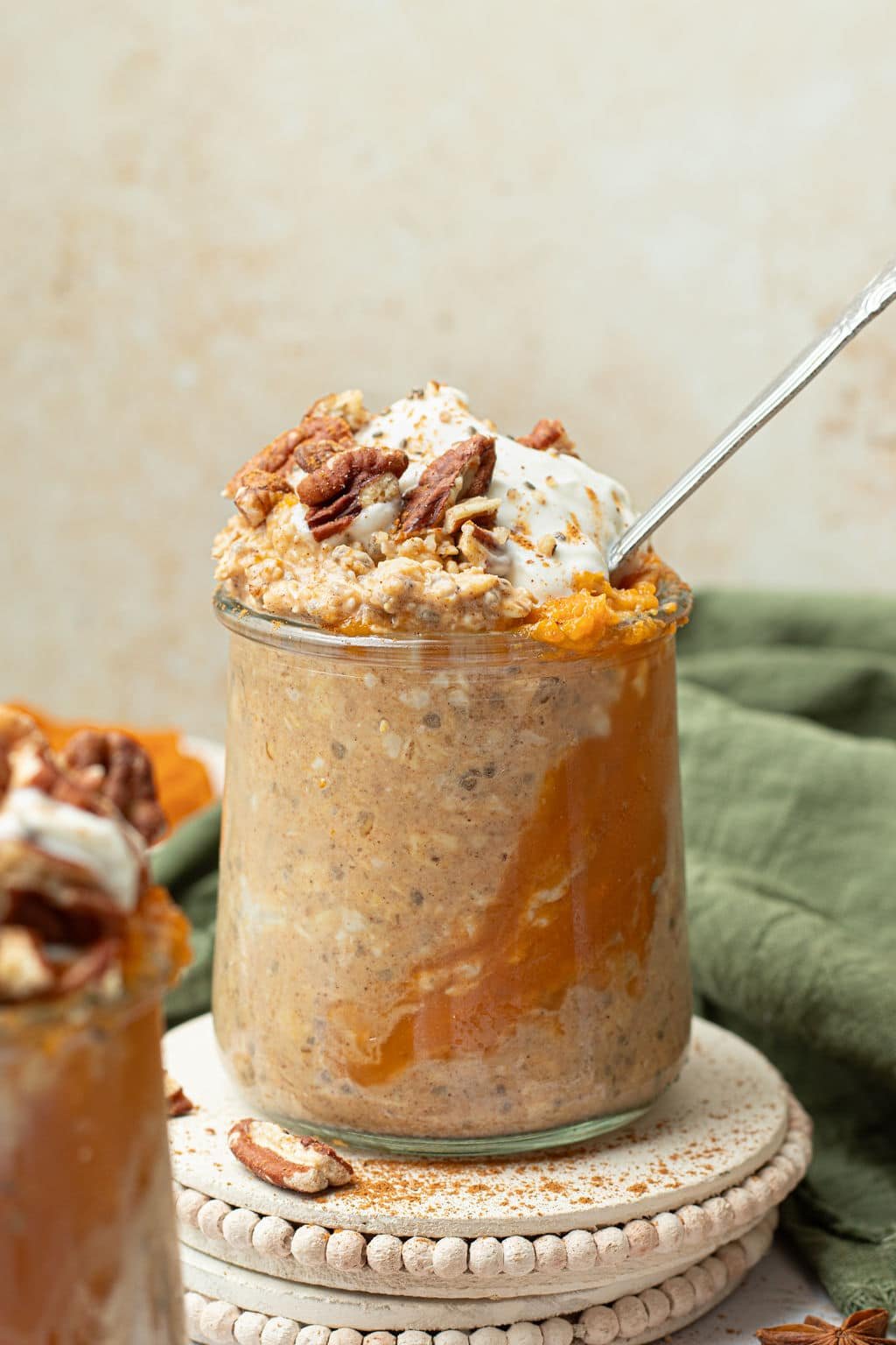 pumpkin overnight oatmeal in glass jar with metal spoon