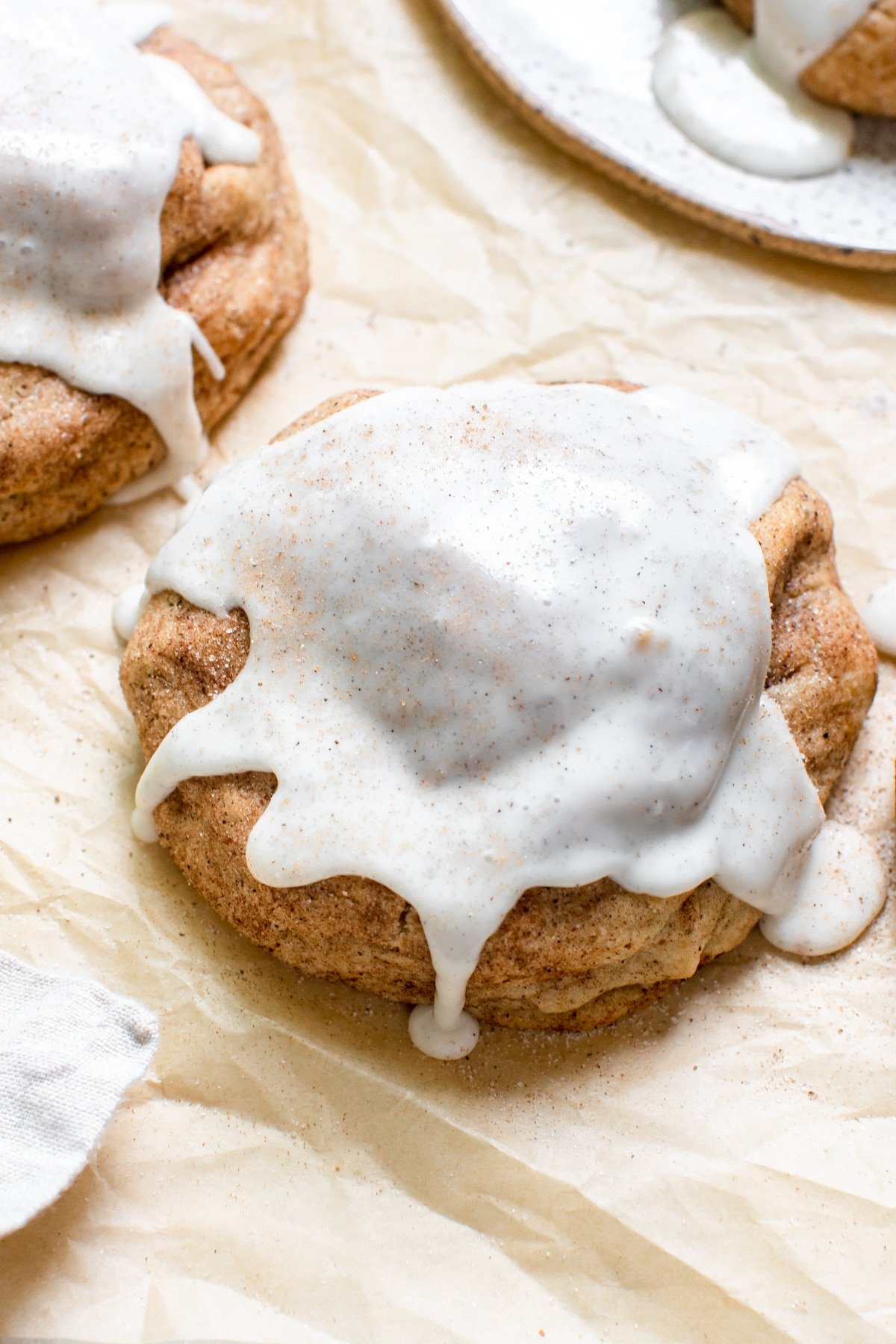 a chai cookies on parchment paper topped with vanilla bean glaze