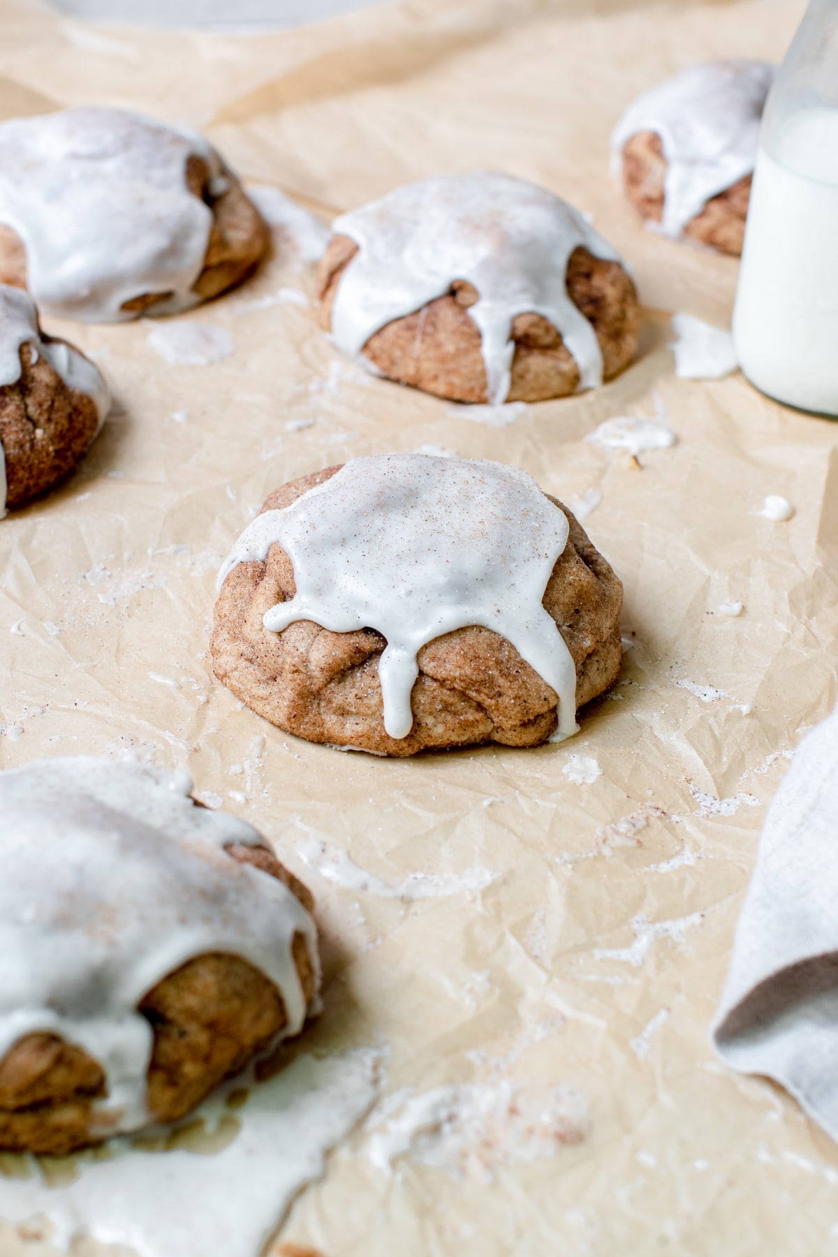 a chai cookies on parchment paper topped with vanilla bean glaze