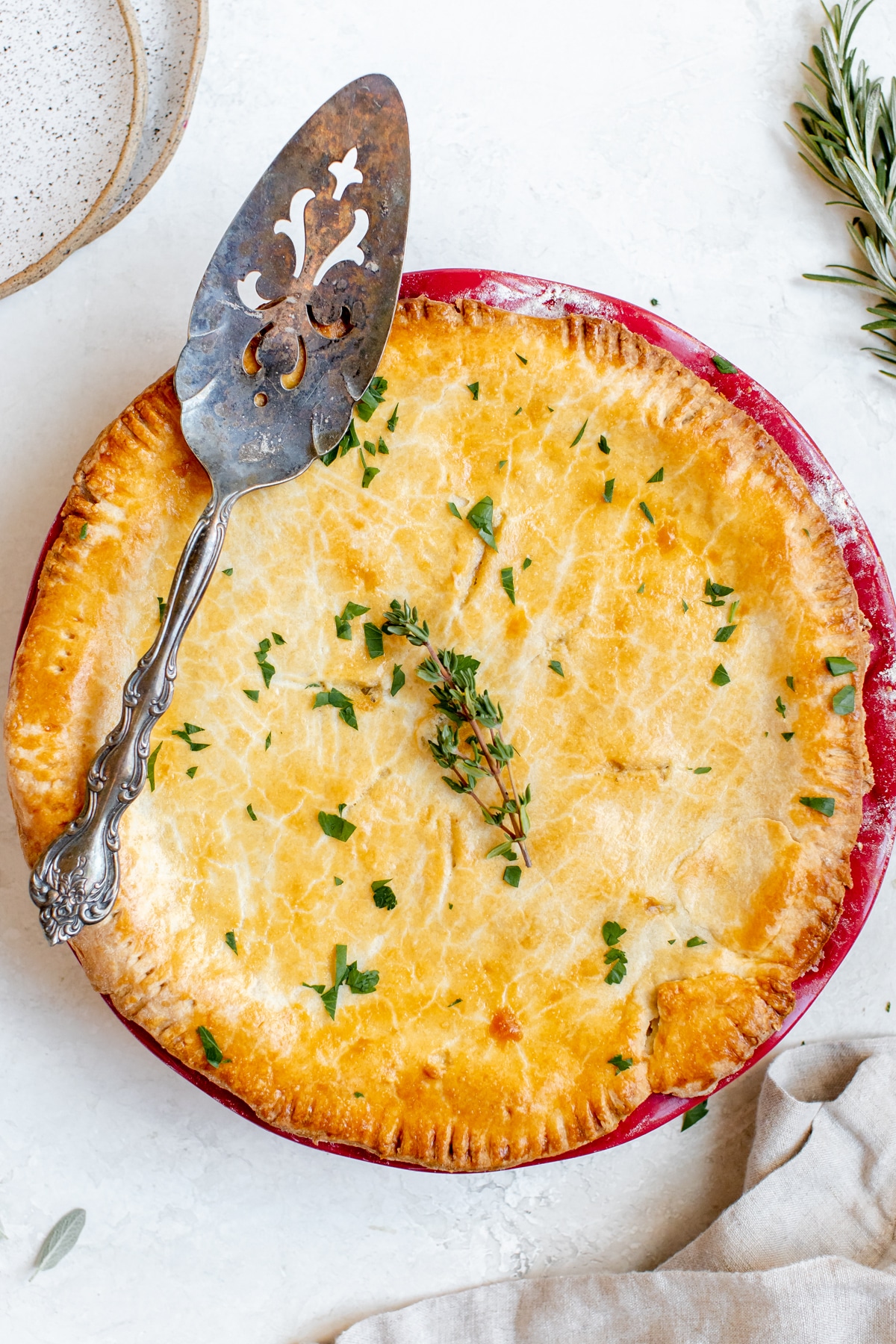 a freshly baked pot pie garnished with thyme on top