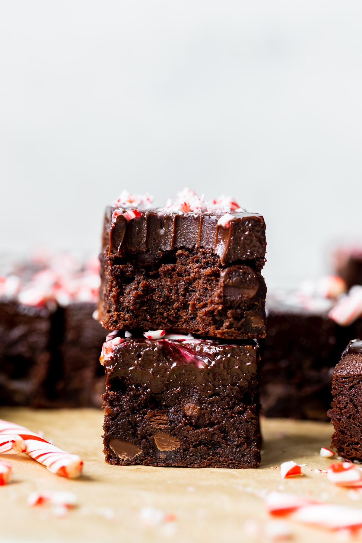 2 brownies stacked on top of each other garnished with crushed peppermint candy canes