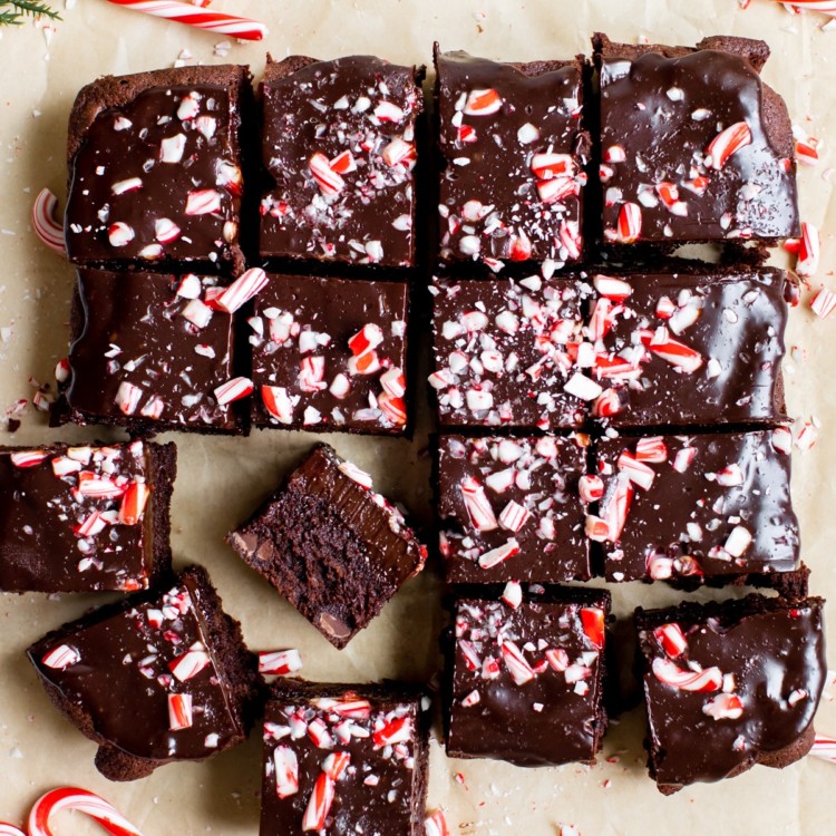 freshly baked brownies on parchment paper topped with candy canes