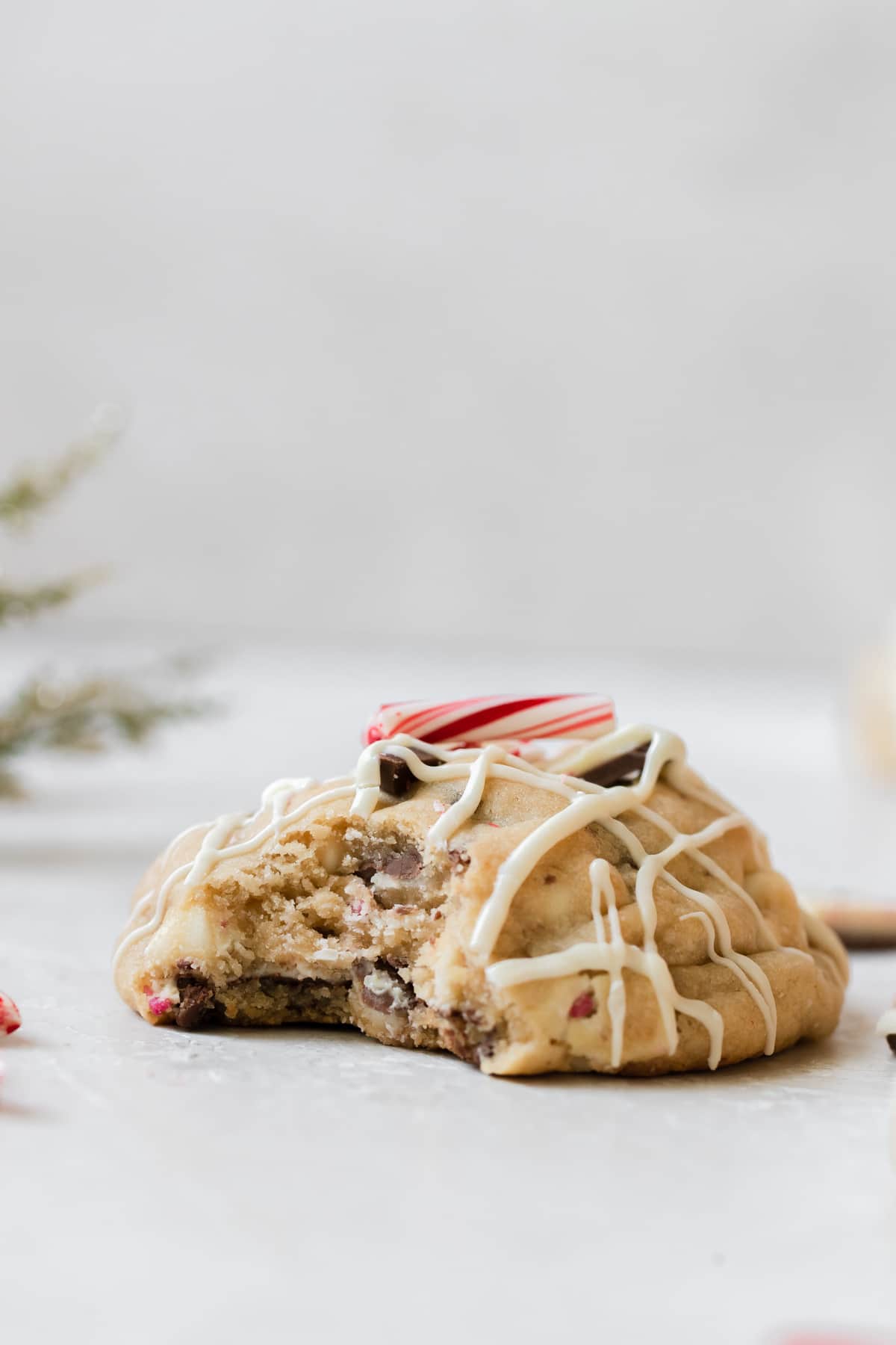 a bite taken out of a cookie that's drizzled with white chocolate