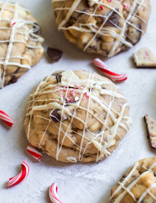 a cookie with white chocolate drizzled on top and crushed candy canes