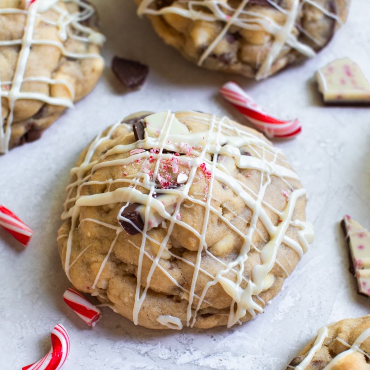 a cookie with white chocolate drizzled on top and crushed candy canes