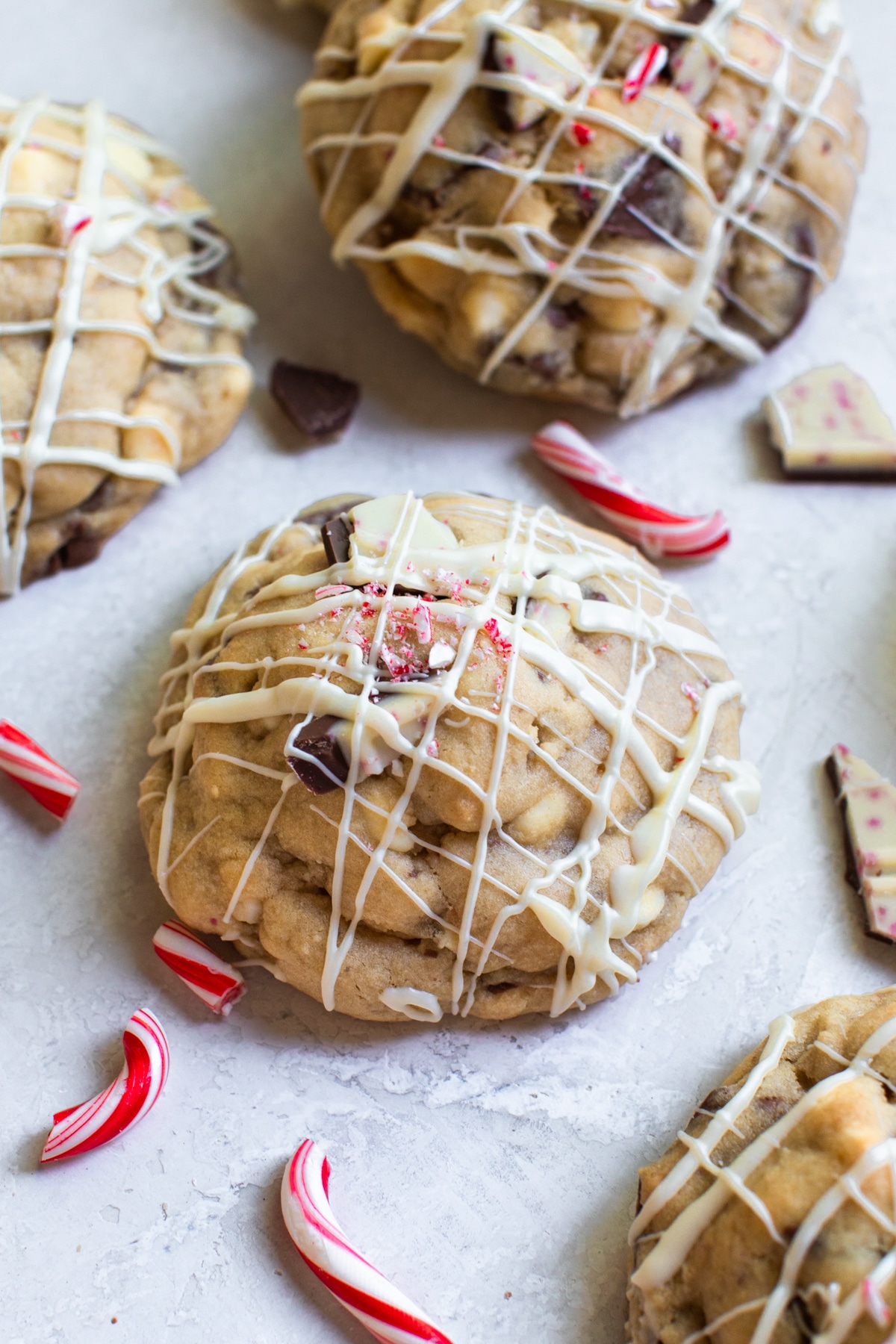a cookie with white chocolate drizzled on top and crushed candy canes