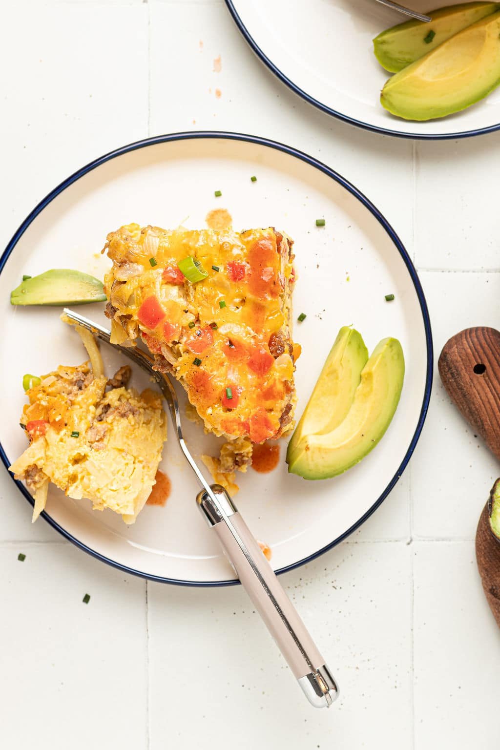 slice of slow cooker breakfast casserole on plate cut with fork