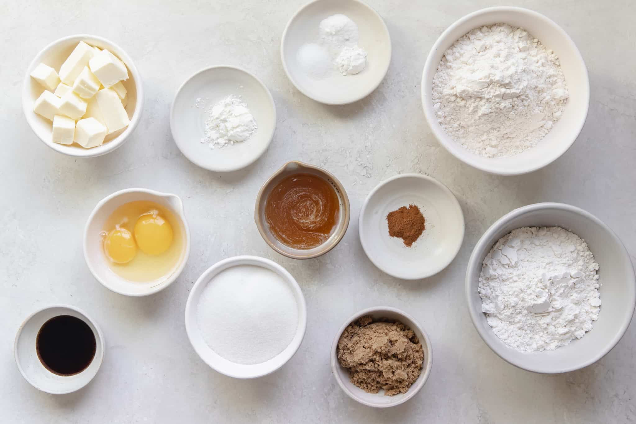 ingredients needed to make honey cookies in small bowls