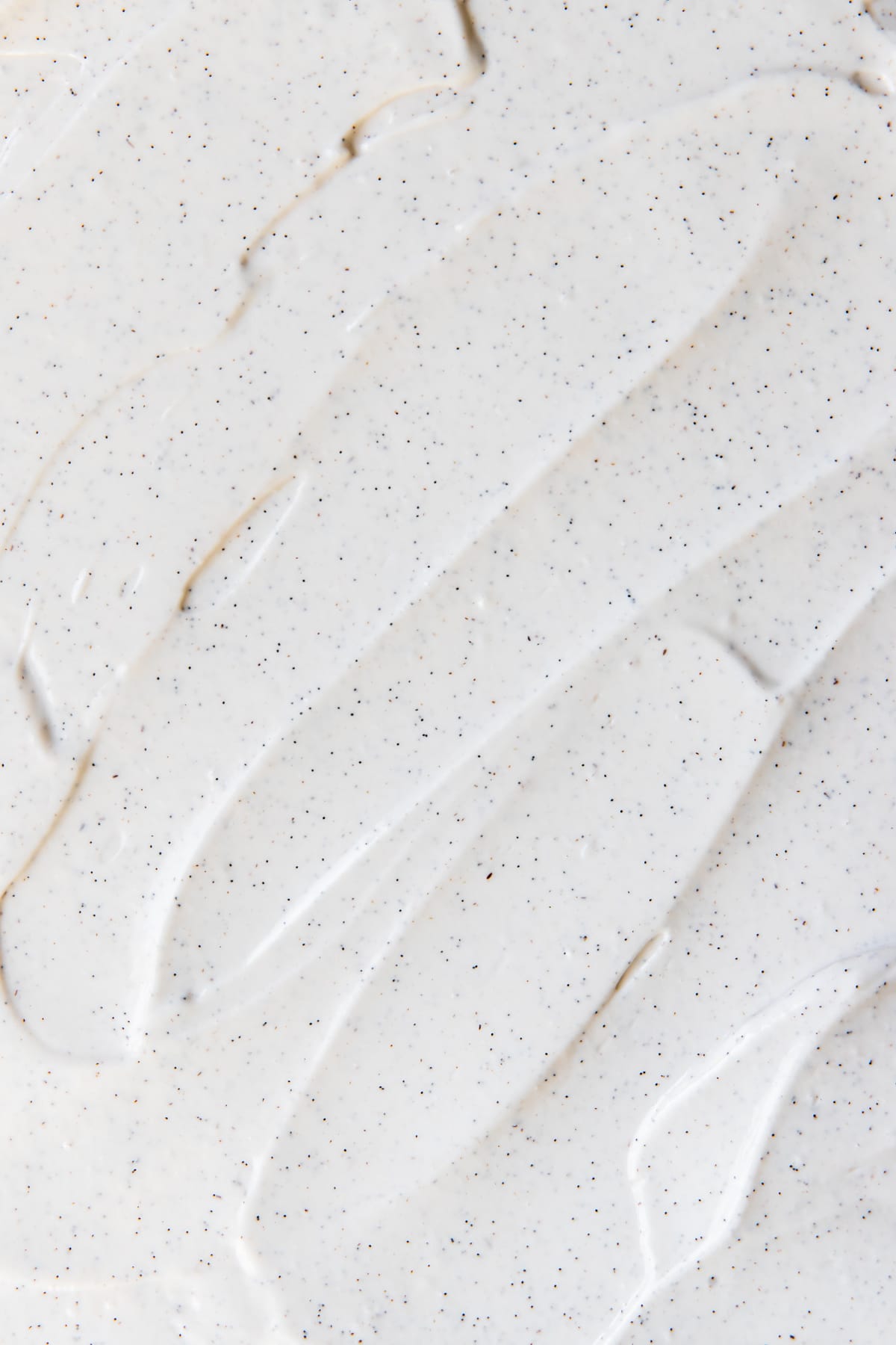 an up close image of sour cream topping with vanilla bean specks 