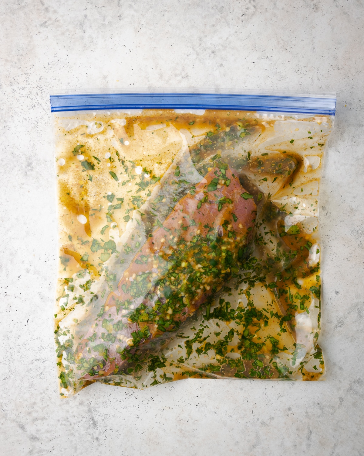 steak in a plastic baggie with carne asada marinade 