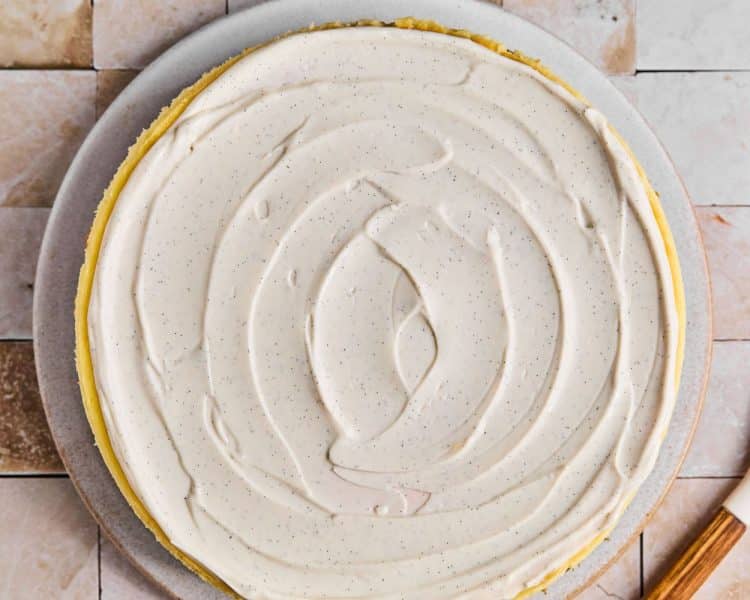 Round cheesecake topped with vanilla bean paste frosting.