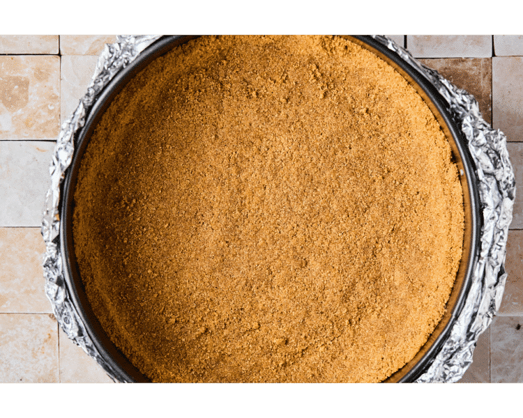 Pie pan with graham cracker pressed into the rim to make a crust, with the outside lined in foil.