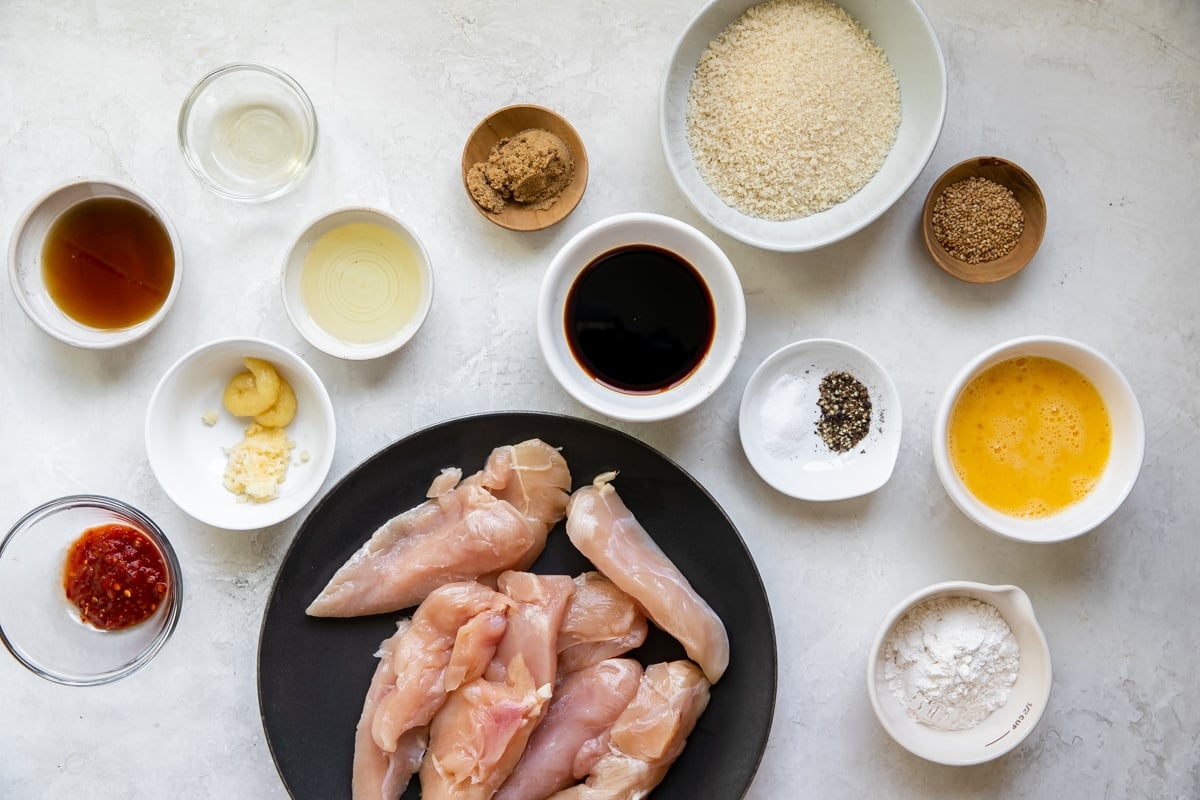 ingredients to make sesame chicken tenders in small bowls