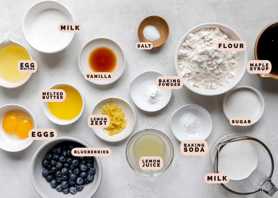 Multi-sized bowls containing the ingredients to make lemon blueberry pancakes