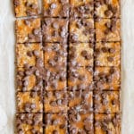 freshly baked caramel bar topped with chocolate chips and flaky sea salt