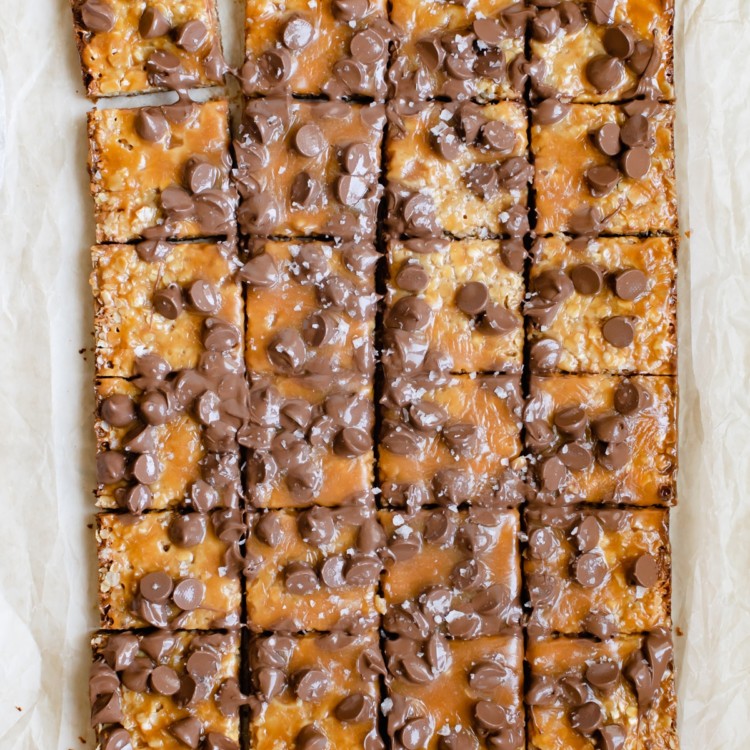 freshly baked caramel bar topped with chocolate chips and flaky sea salt